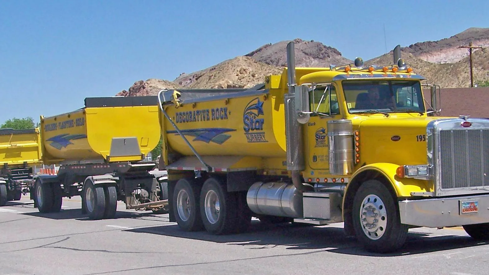Yellow decorative rock dump truck with a matching trailer